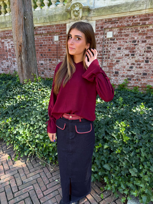 Second front view of burgundy v-neck sweater with tie sleeve detail