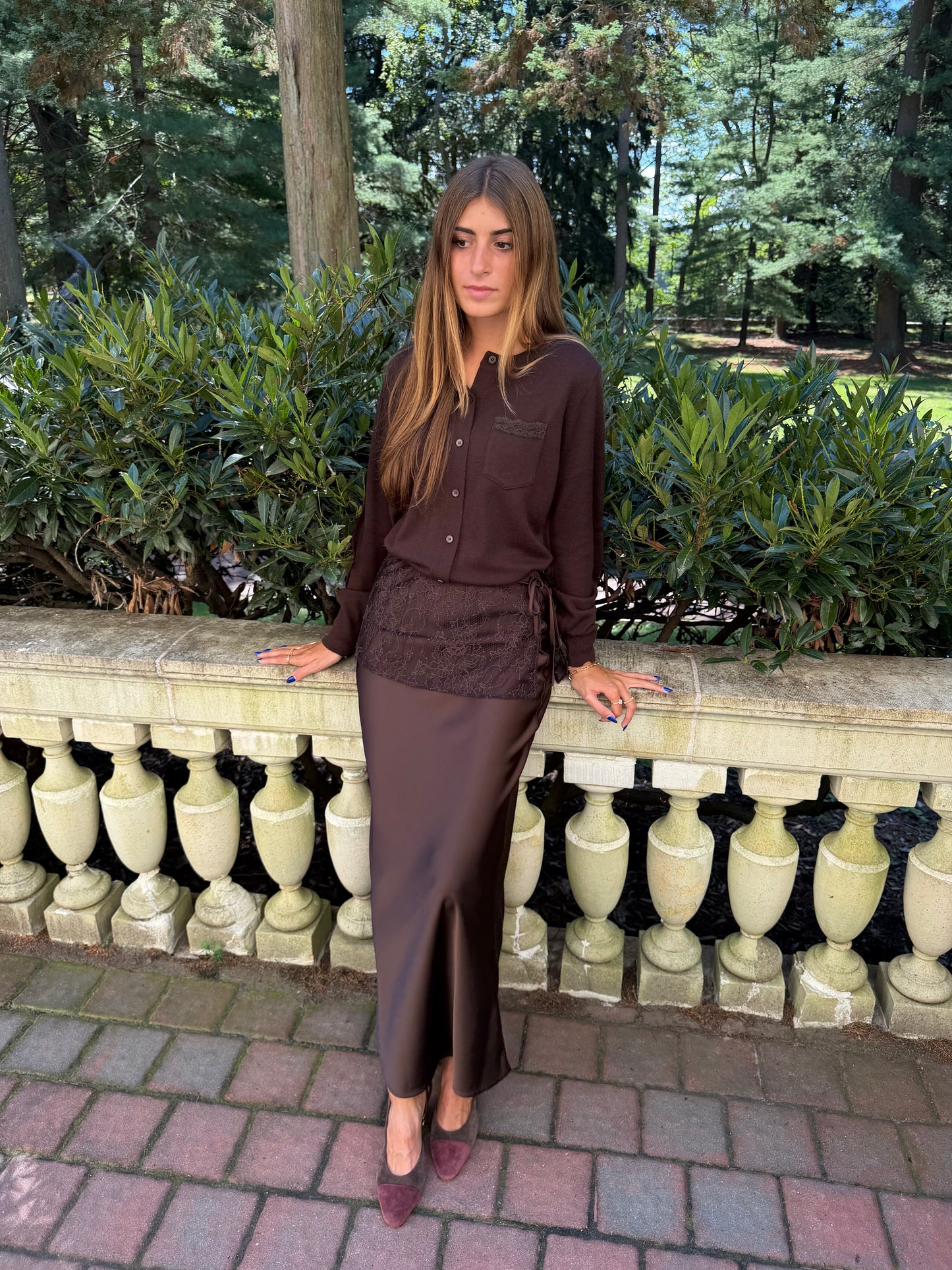Front view of chocolate brown slip skirt with lace overlay