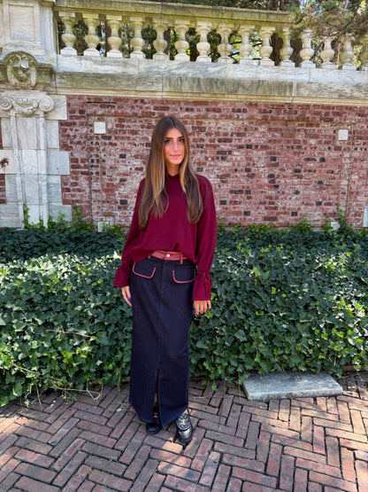 Front view of burgundy v-neck sweater with tie sleeve detail