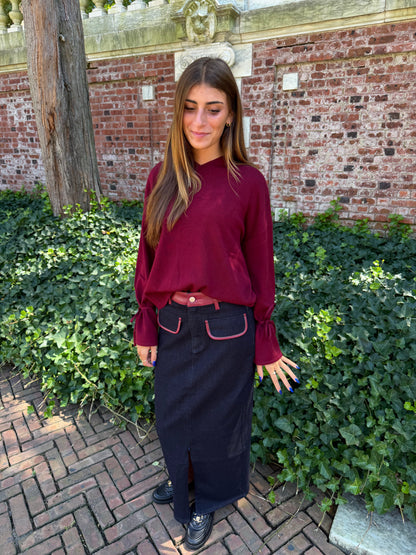 Third front view of burgundy v-neck sweater with tie sleeve detail