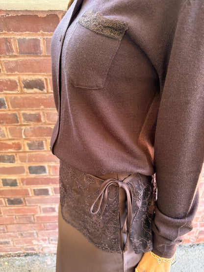 Close up view of chocolate brown cardigan with lace trim pocket detail on chest