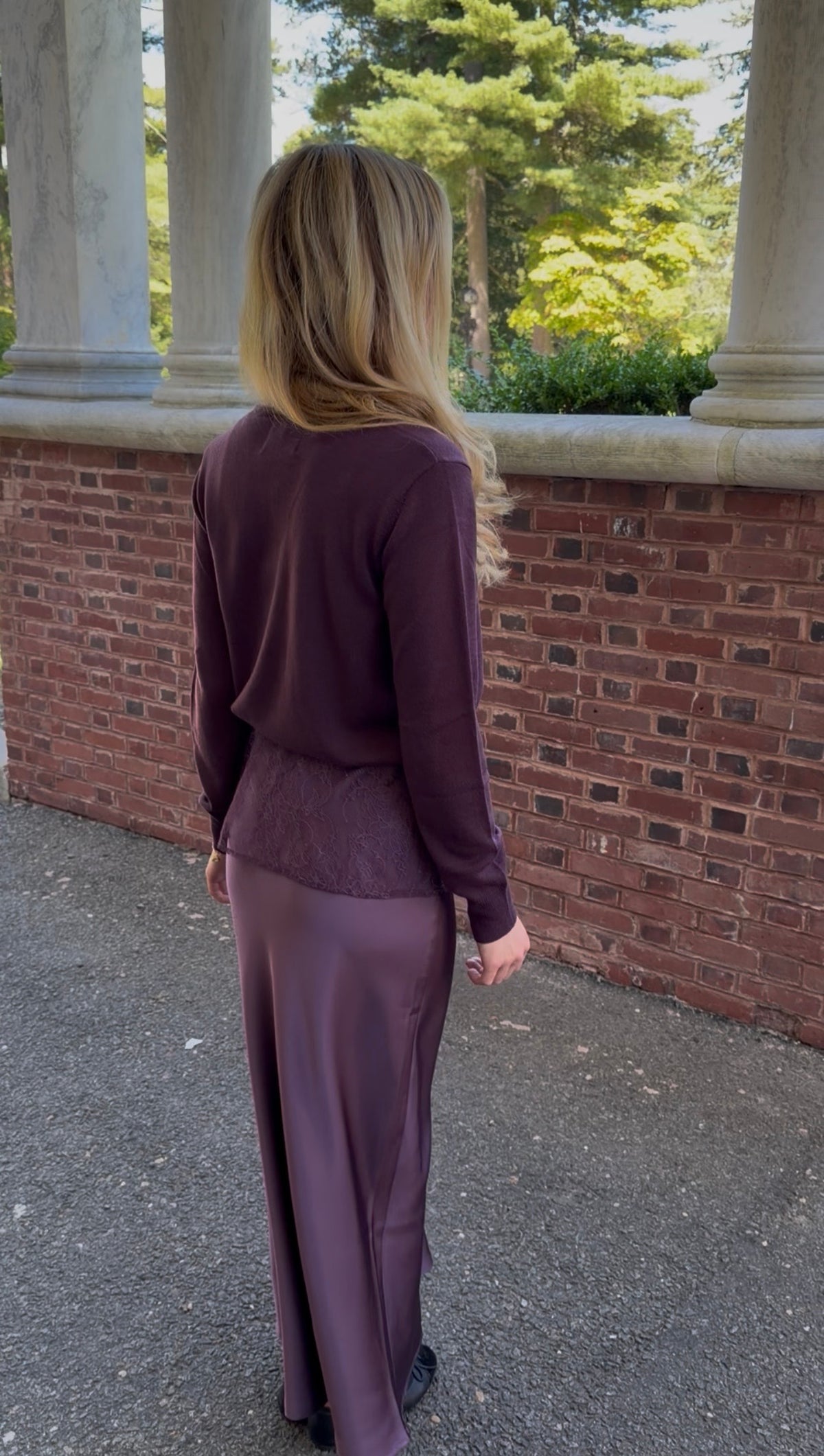 Back view of plum cardigan with lace trim pocket detail on chest