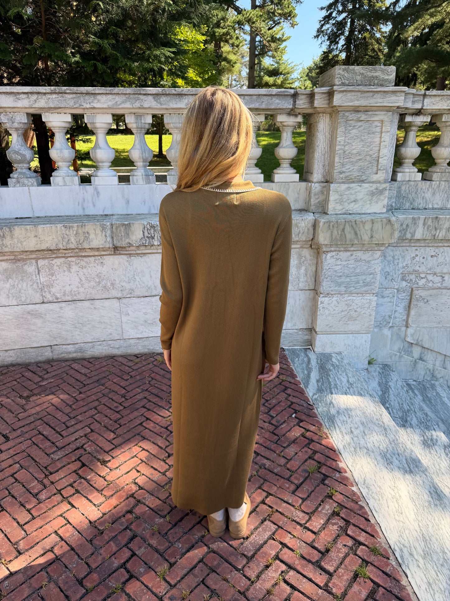 Back view of olive green polo knit dress with oat contrast stitching and collar placket detail