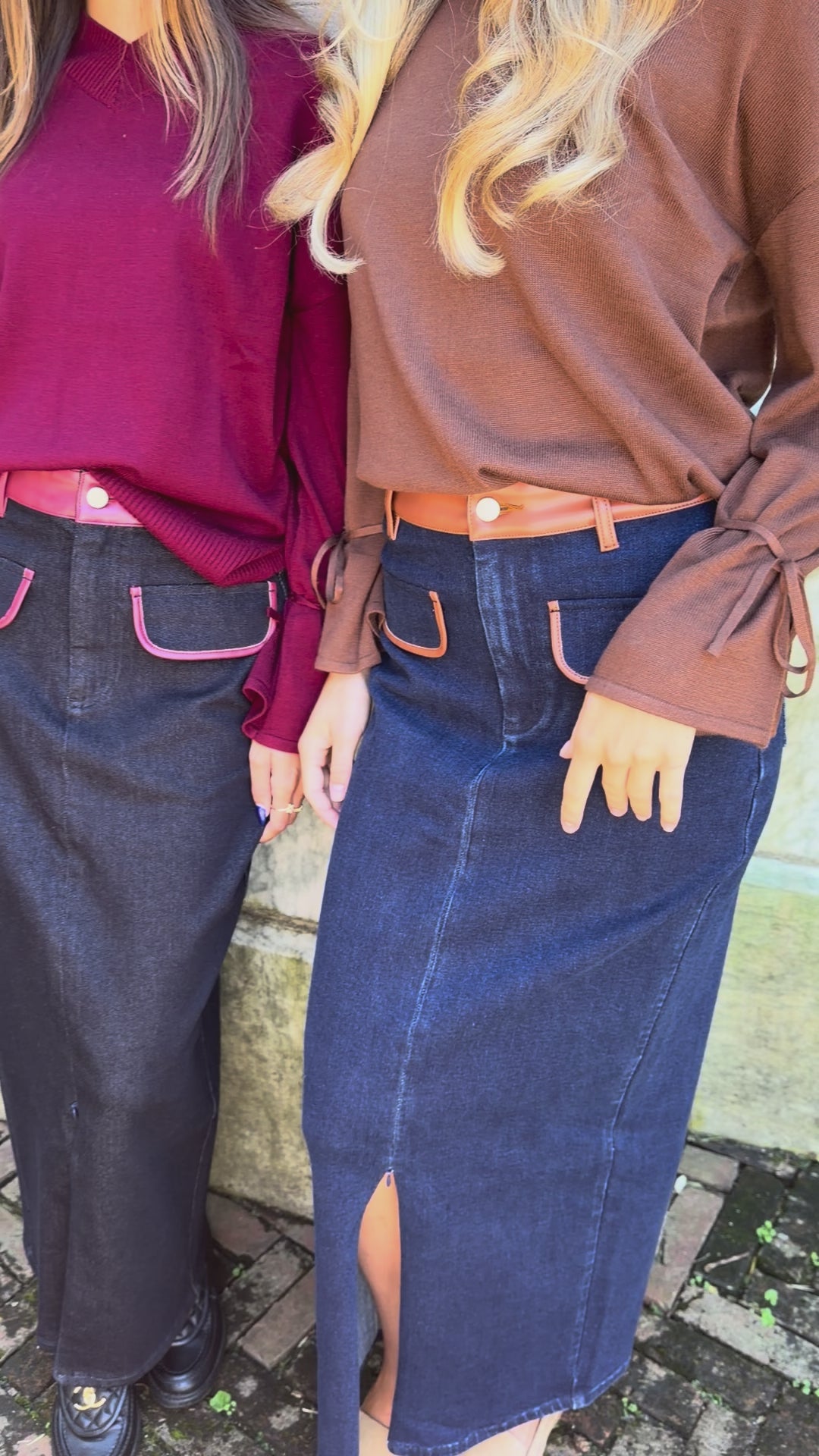 Video of blue denim maxi skirt with chestnut leather trim detail, front flap pockets and zipper closure slit and black denim maxi skirt with burgundy leather trim detail, front flap pockets and zipper closure slit